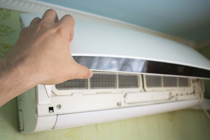 Blog Title: Is It Normal for My AC to Turn On and Off? Photo: Mounted AC Unit